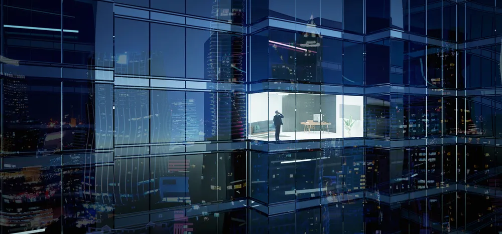 Man standing in business building making a phone call