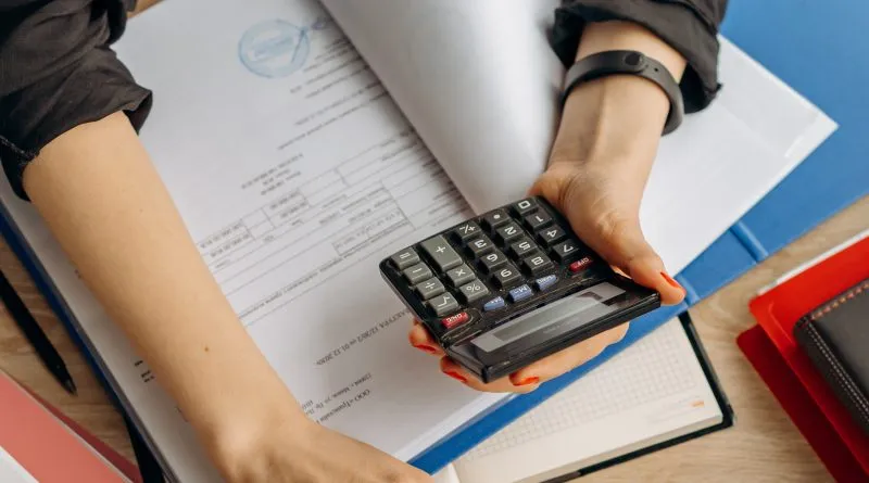 person holding calculator