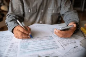 A man completing his tax forms by hand.