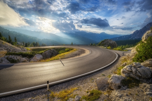 Windy road with clouds in the background