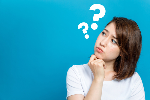 Woman holding her chin with a question mark above her