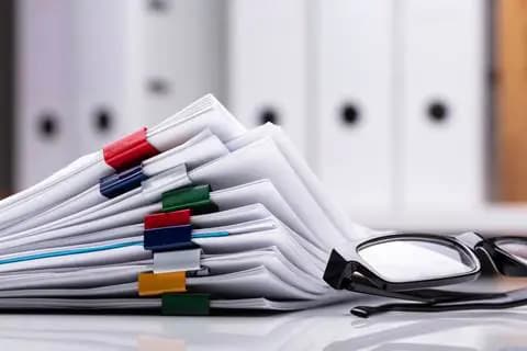 Stack of papers with glasses